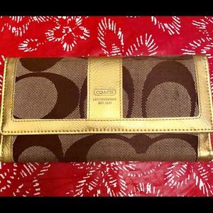 Coach wallet color brown & gold.
